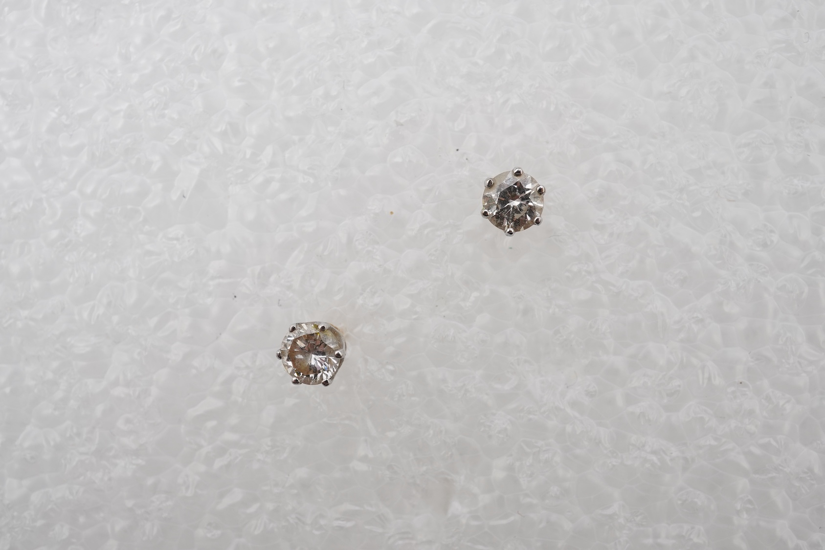 A pair of diamond stud earrings